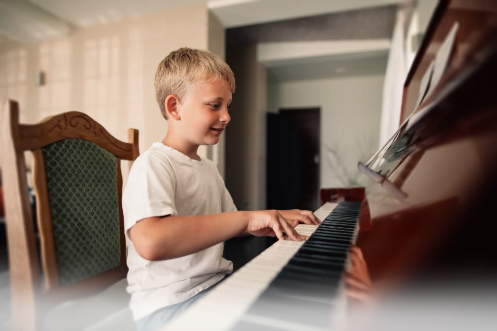 Child playing keyboard as a beginner