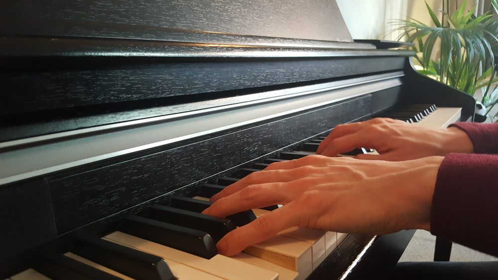 Beginner pianist practicing scales: Essential easy finger exercises for beginner piano