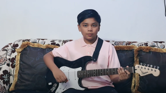 Student at the mystic keys plays electric guitar