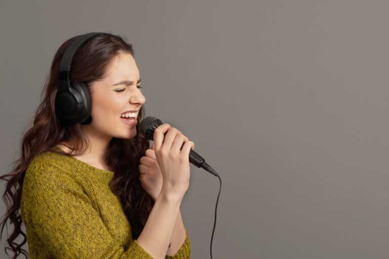 girl singing in a studio used in a blog about what to drink for clear voice