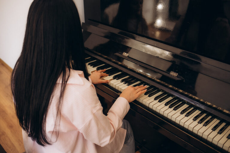 girls playing a popular song on piano