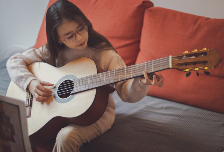 little girl practicing guitar