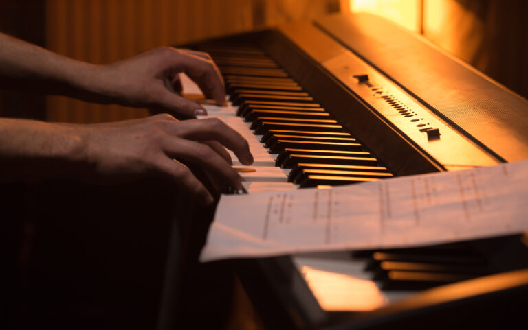hands shown playing piano