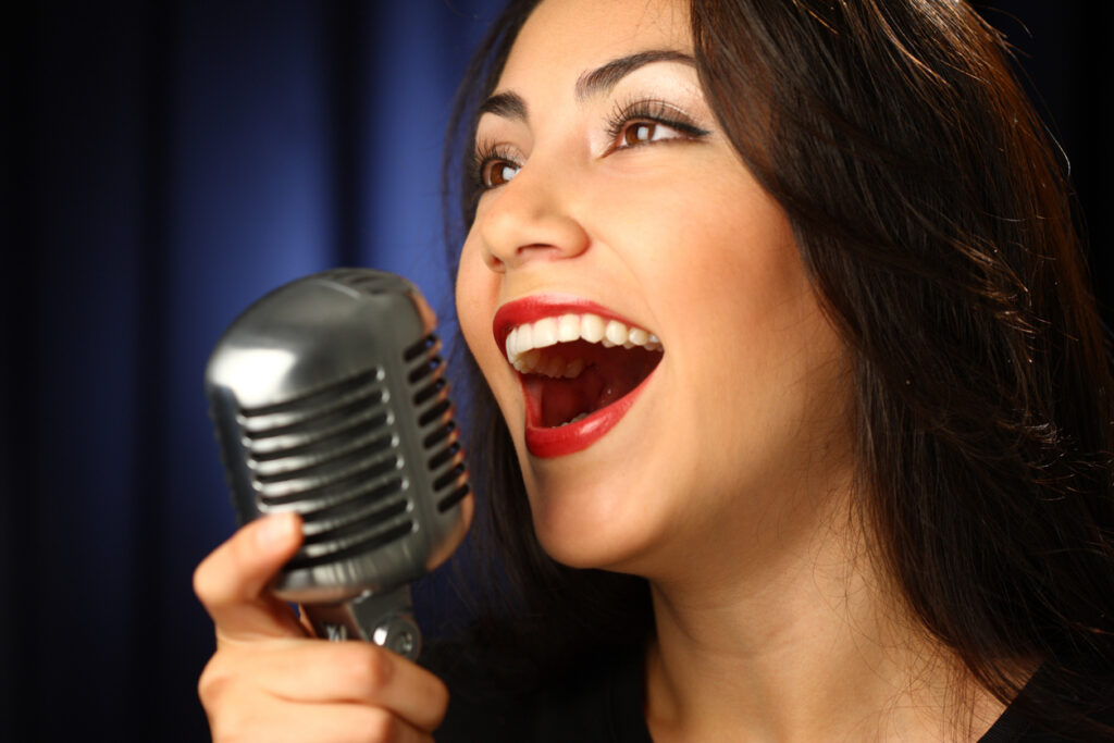 Woman singing with vintage microphone