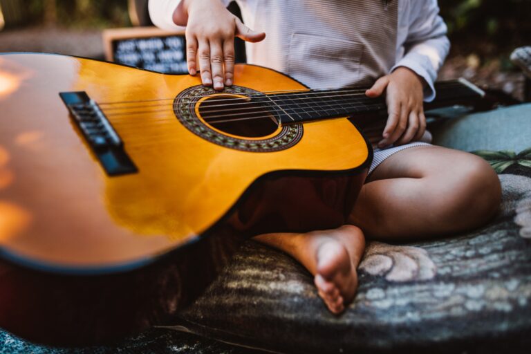 child holding a guitar