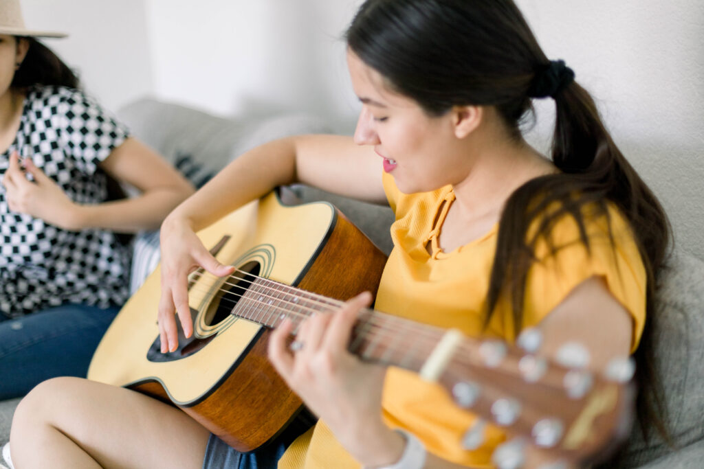 girl playing a guitar