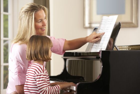mom and son playing piano together