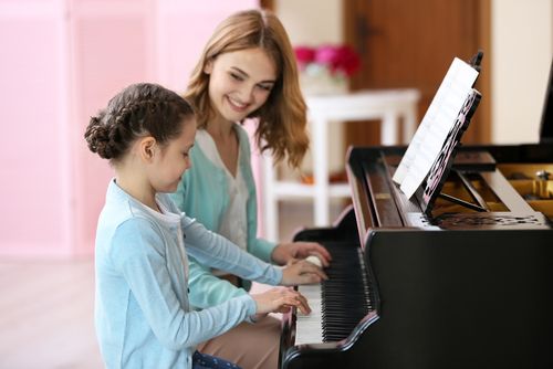 Improving Piano Playing by Ear for Intermediate Students- girl learning piano
