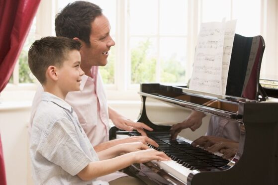 Improving Piano Playing by Ear for Intermediate Students​- Boy playing piano