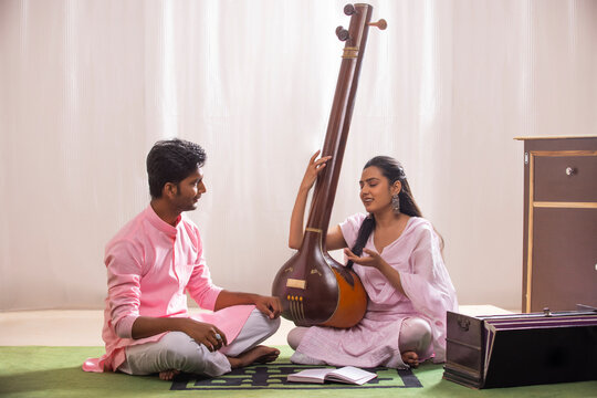 woman playing tanpura- seeking feedback