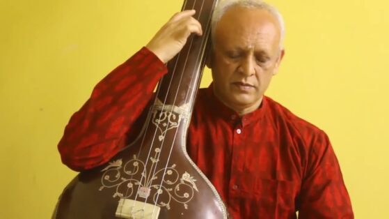 Man playing Tanpura