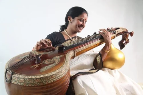 Carnatic music benefits | women playing Veena