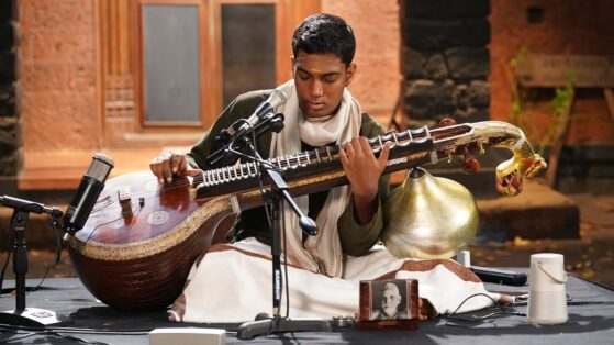 Carnatic music terms- Man playing veena