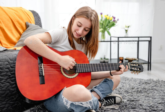 Finger Picking Techniques - girl playing guitar