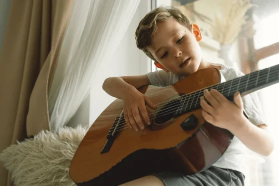 Finger Picking Techniques - boy playing guitar