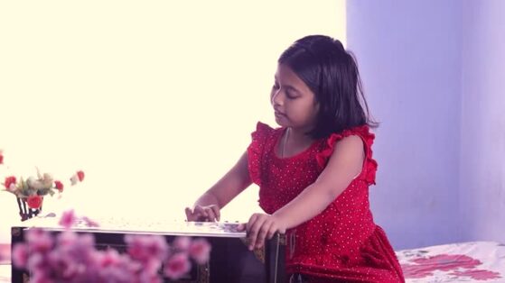 Hindustani music for children- girl playing harmonium