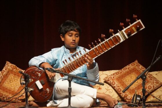 Hindustani music for children- boy splaying SItar