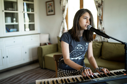 Girl playing piano & singing