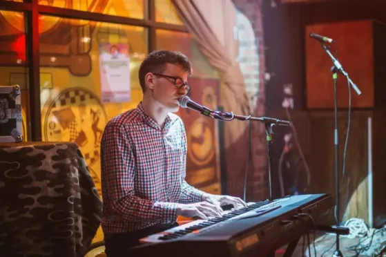 Man playing piano & singing