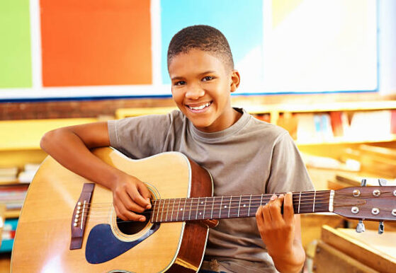 boy playing guitar | Learn electric guitar at 12