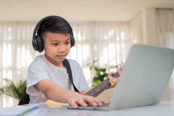 Boy learning Electric Guitar Online