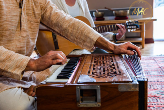 man playing harmonium
