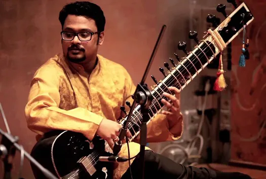 Hindustani music popularity UAE. Man playing Sitar