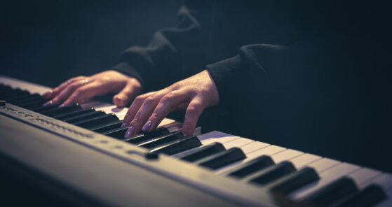 Woman playing piano worship chords