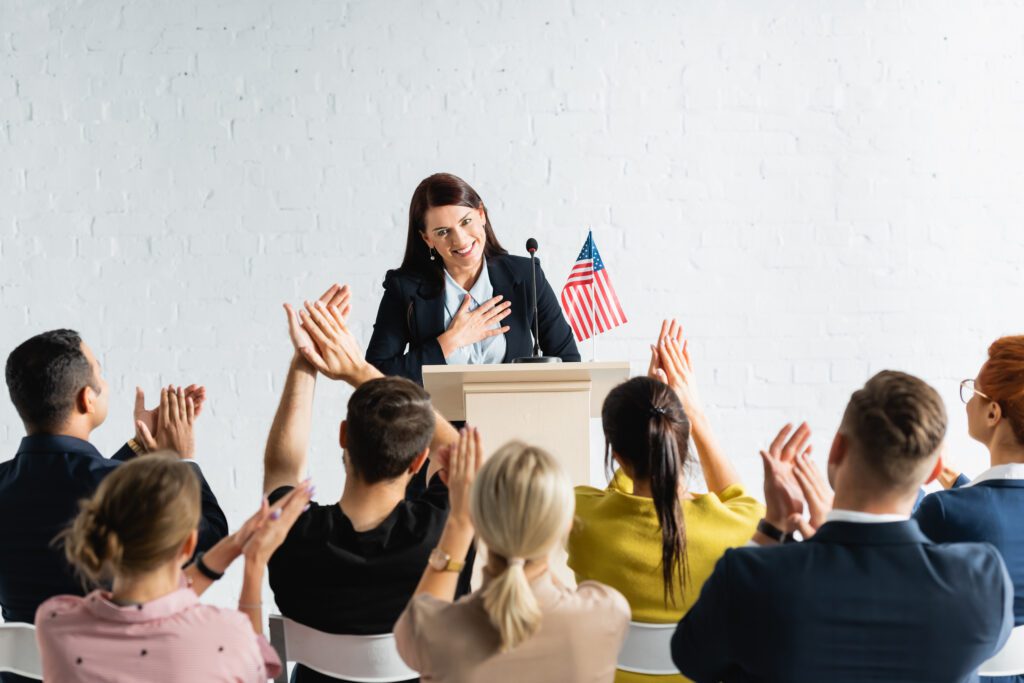 a woman using her public speaking skills in front of candidates