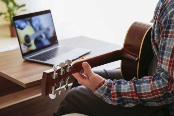 Online Music Education | man playing guitar