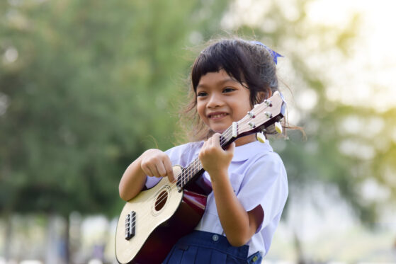 Kid playing Ukulele