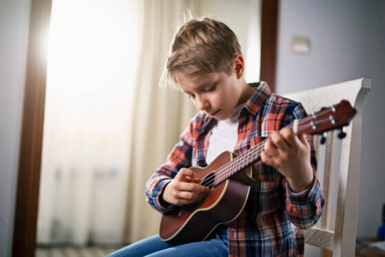 Kid playing Ukulele