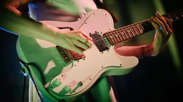 Girl learning to play guitar