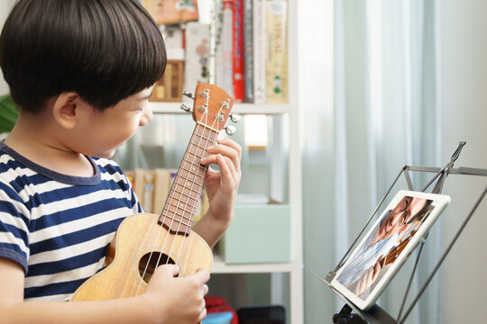 Boy playing ukulele