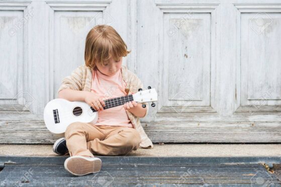 Boy playing ukulele