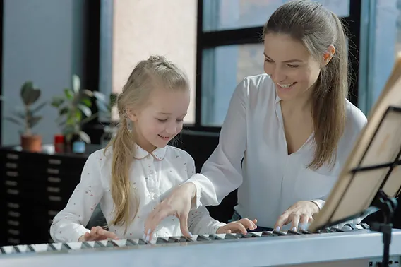 Parents and child playing piano