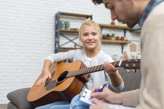 Parents and child playing guitar