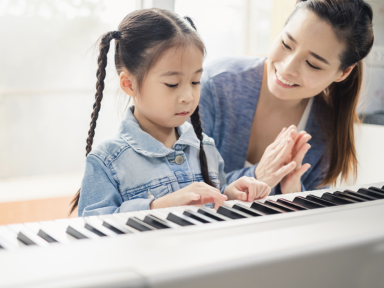 Parents and child playing piano