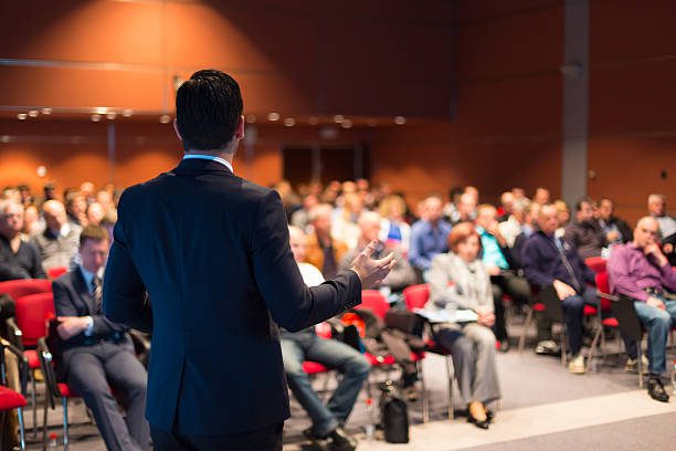 A man giving a speech demonstrating how to structure your speech for maximum impact