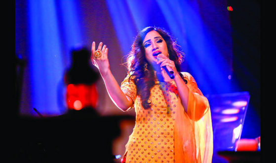 Shreya Ghoshal singing live on stage, the iconic Indian playback singer admired for her hit songs and soulful performances.