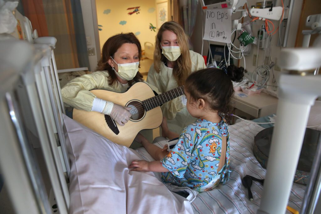 Doctor and patient listening to music in a hospital setting – unusual ways music is used in medicine to promote relaxation and healing