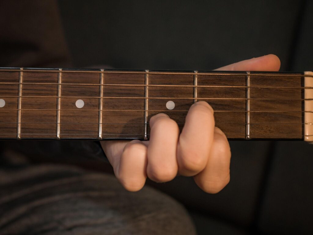 beginner practicing basic worship guitar chords on acoustic guitar