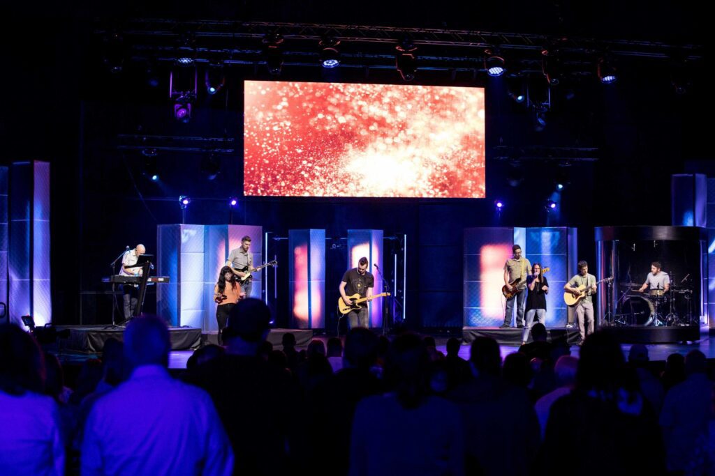Worship band playing instruments together during church serviceSinging with Purpose