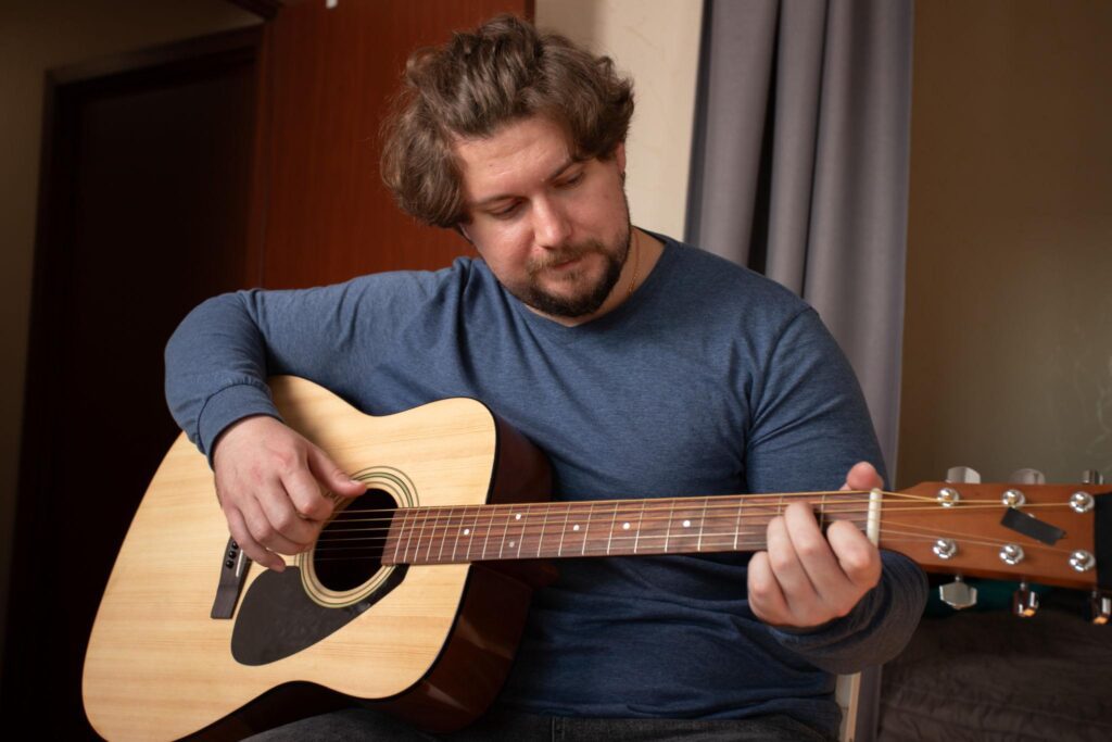Guitar live performance practice with a musician selecting songs for a concert.