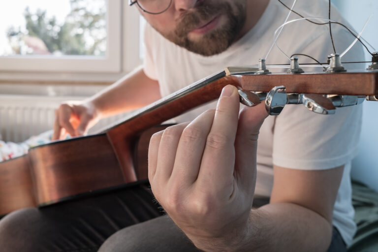 play guitar at the fretboard