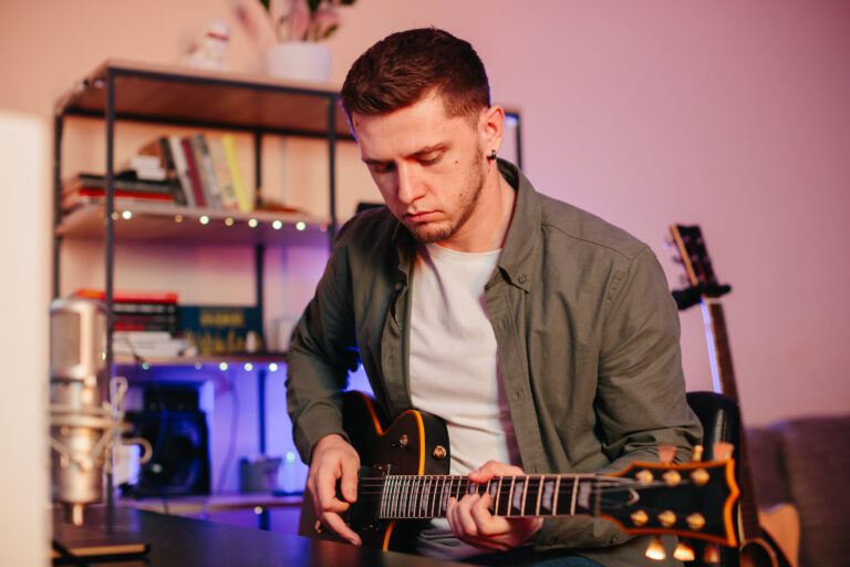 play guitar at the fretboard