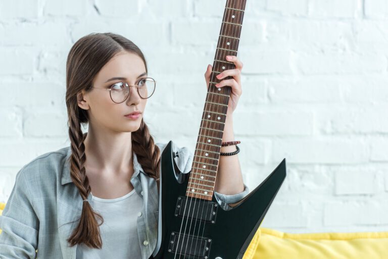 play guitar at the fretboard