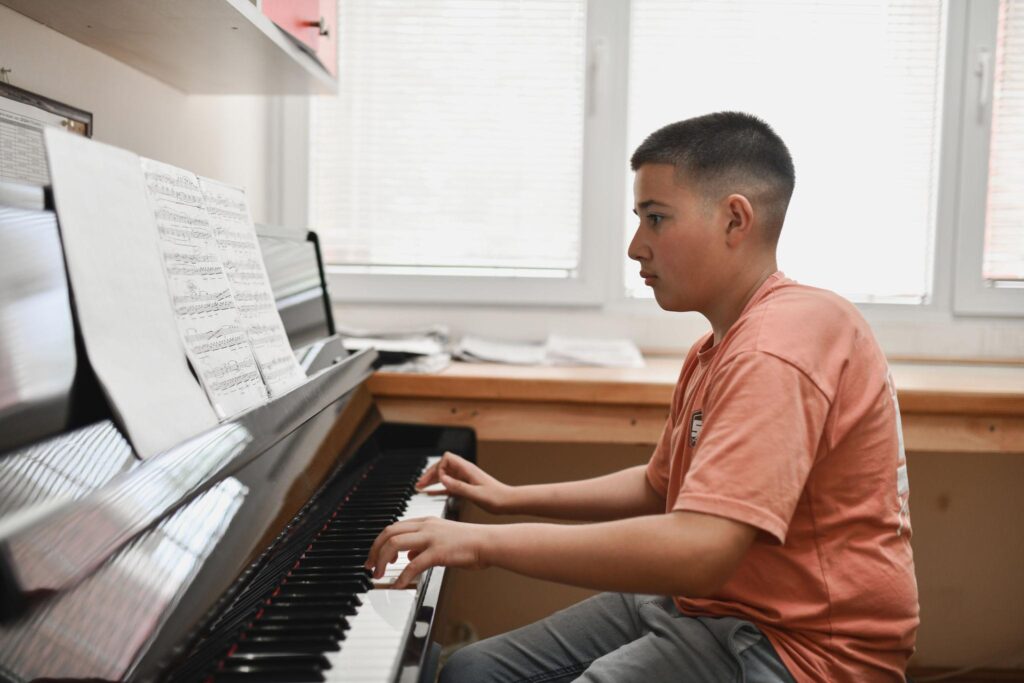 Piano player practicing regularly to improve performance confidence and reduce piano performance anxiety.